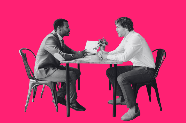 Two people sitting at a table having a conversation